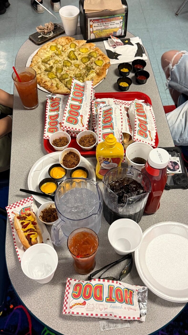 Party food spread — pizza and hot dogs