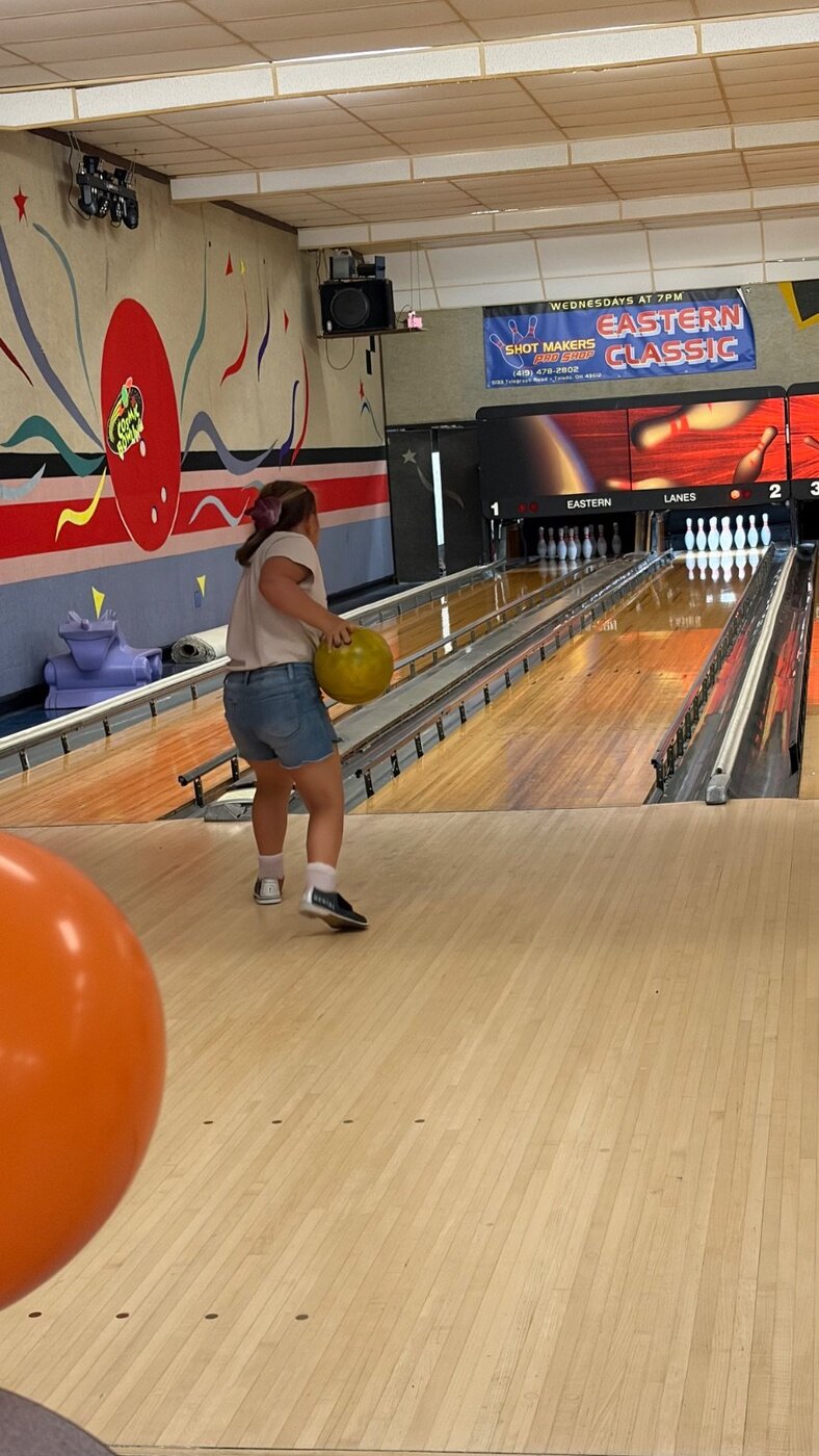 Young bowler rolling the ball down the lane